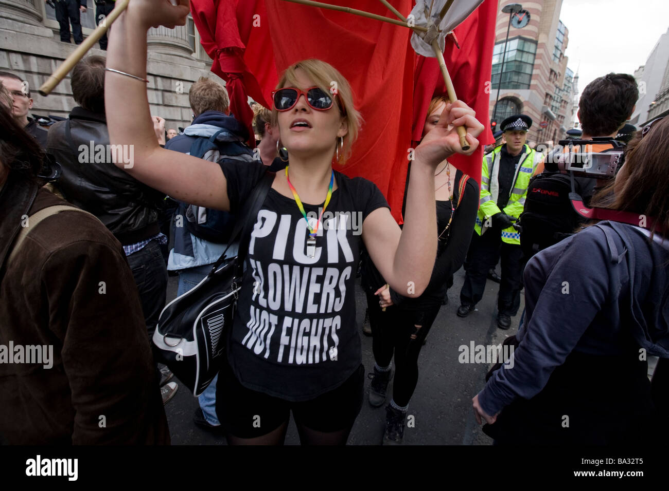 A female protaster flies a red flag at the G20 protest at Bank of England Stock Photo