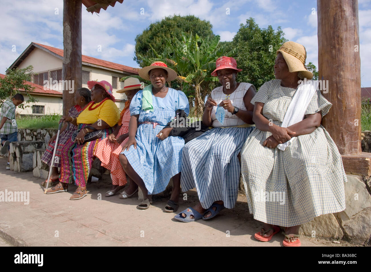 Garifuna women sitting on a bench during the annual Garifuna festival in Livingston, Guatemala. Stock Photo
