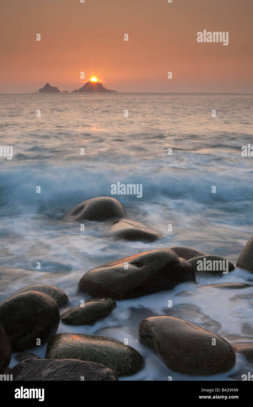 Sunset over the Brisons from Porth Nanven in Cornwall. Stock Photo