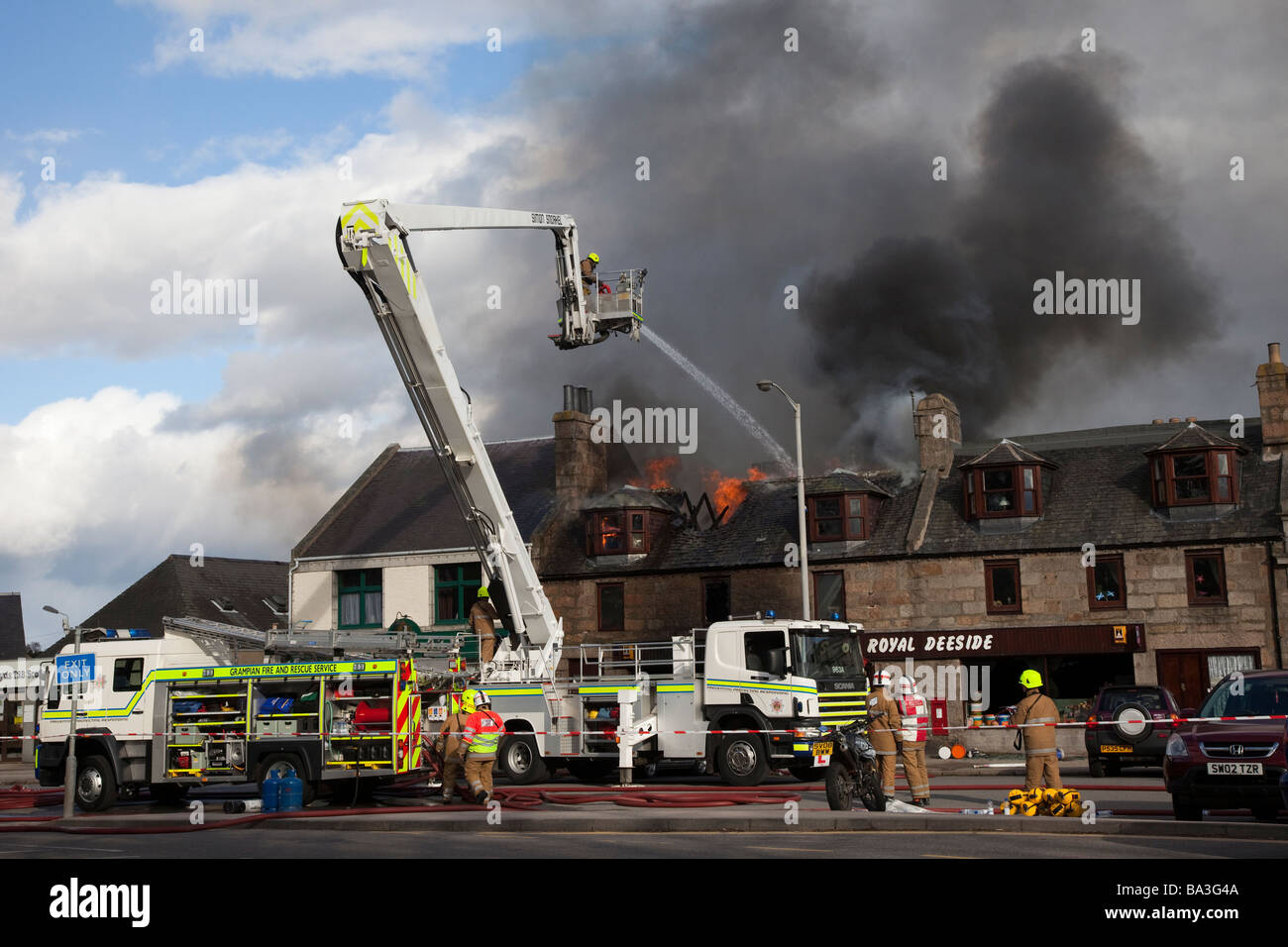 Firemen fighting Shop fire. Firefighter at scene at George Strachan’s of Aboyne, Aberdeenshire, Scotland Stock Photo
