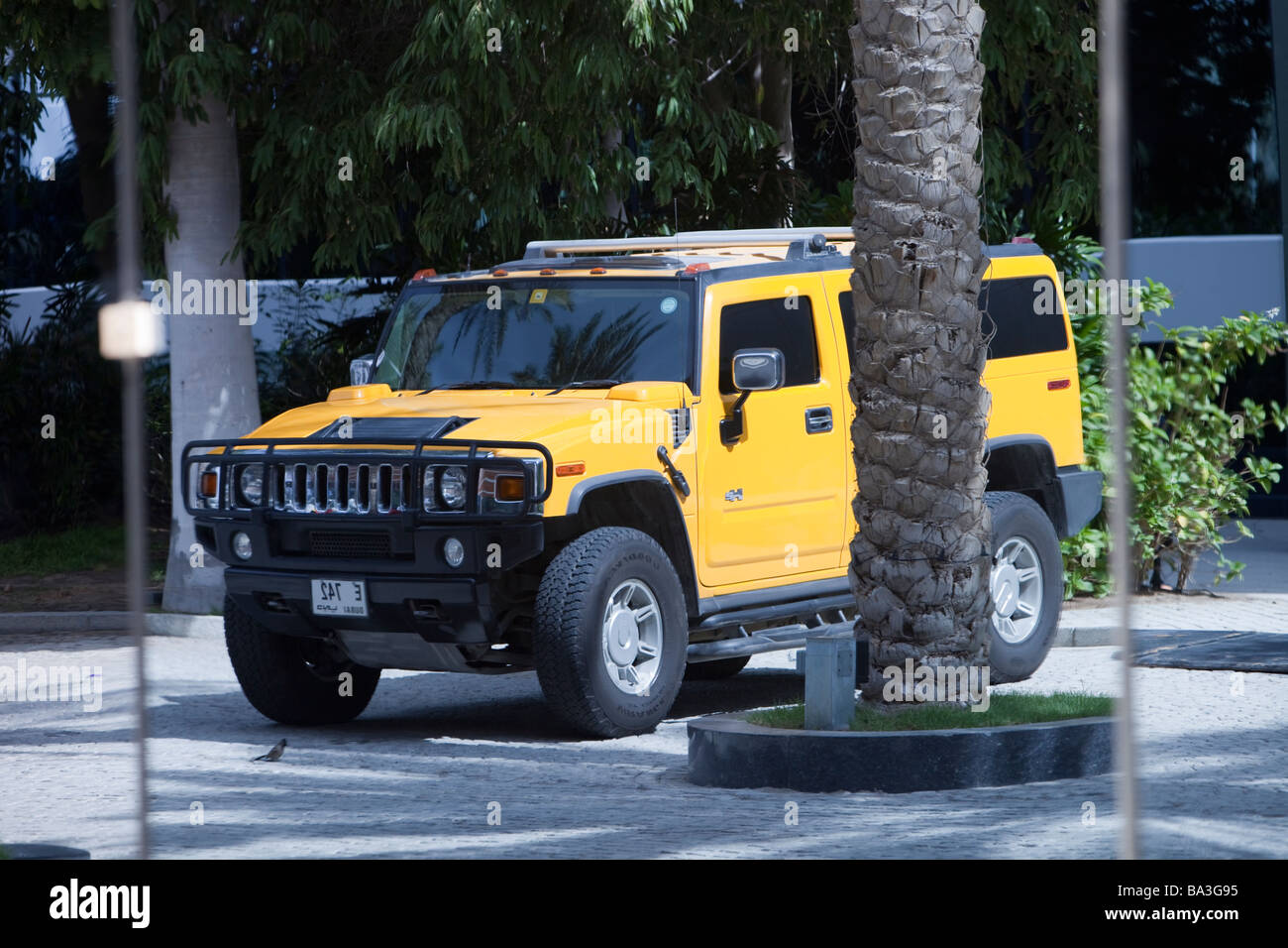 A Hummer reflected in a glass window in Dubai Stock Photo