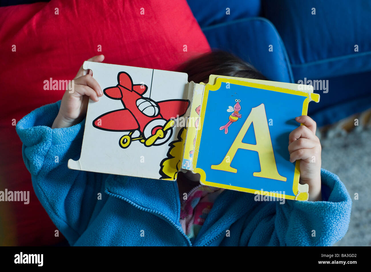 Preschool child reading a letter book. Stock Photo