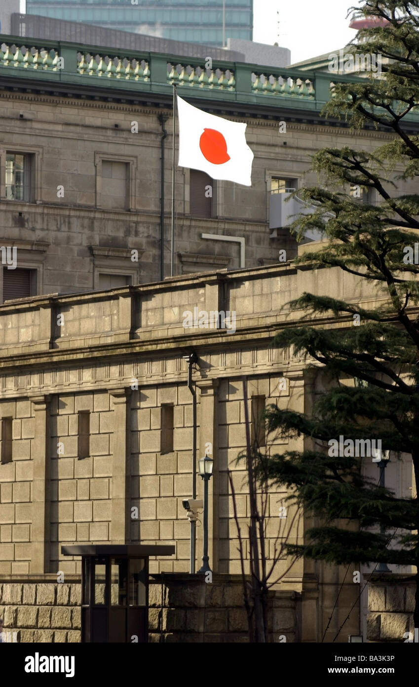 A Japanese flag the Hinomaru flies outside the Bank of Japan in Tokyo Stock Photo