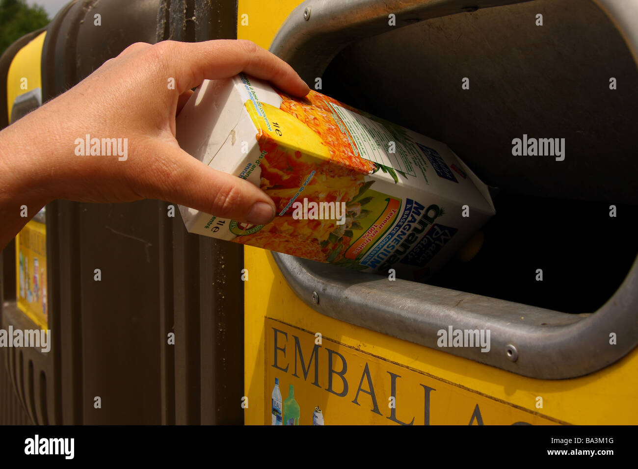 Someone putting a juice carton into a recycling bin Limousin France