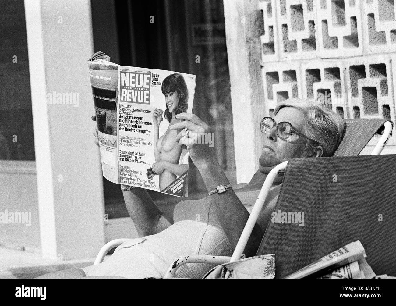 Seventies, black and white photo, people, woman in a deckchair reads a magazine, sunbath, swimsuit, aged 50 to 60 years, Spain, Balearic Islands, Majorca Stock Photo