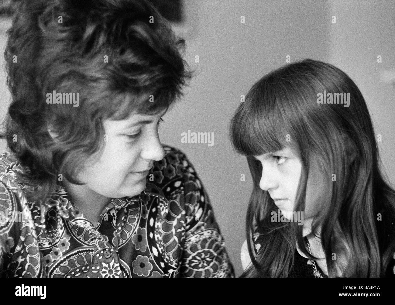 Seventies, black and white photo, people, young woman talking with a girl, aged 30 to 40 years, aged 10 to 12 years, Doris, Birgit Stock Photo