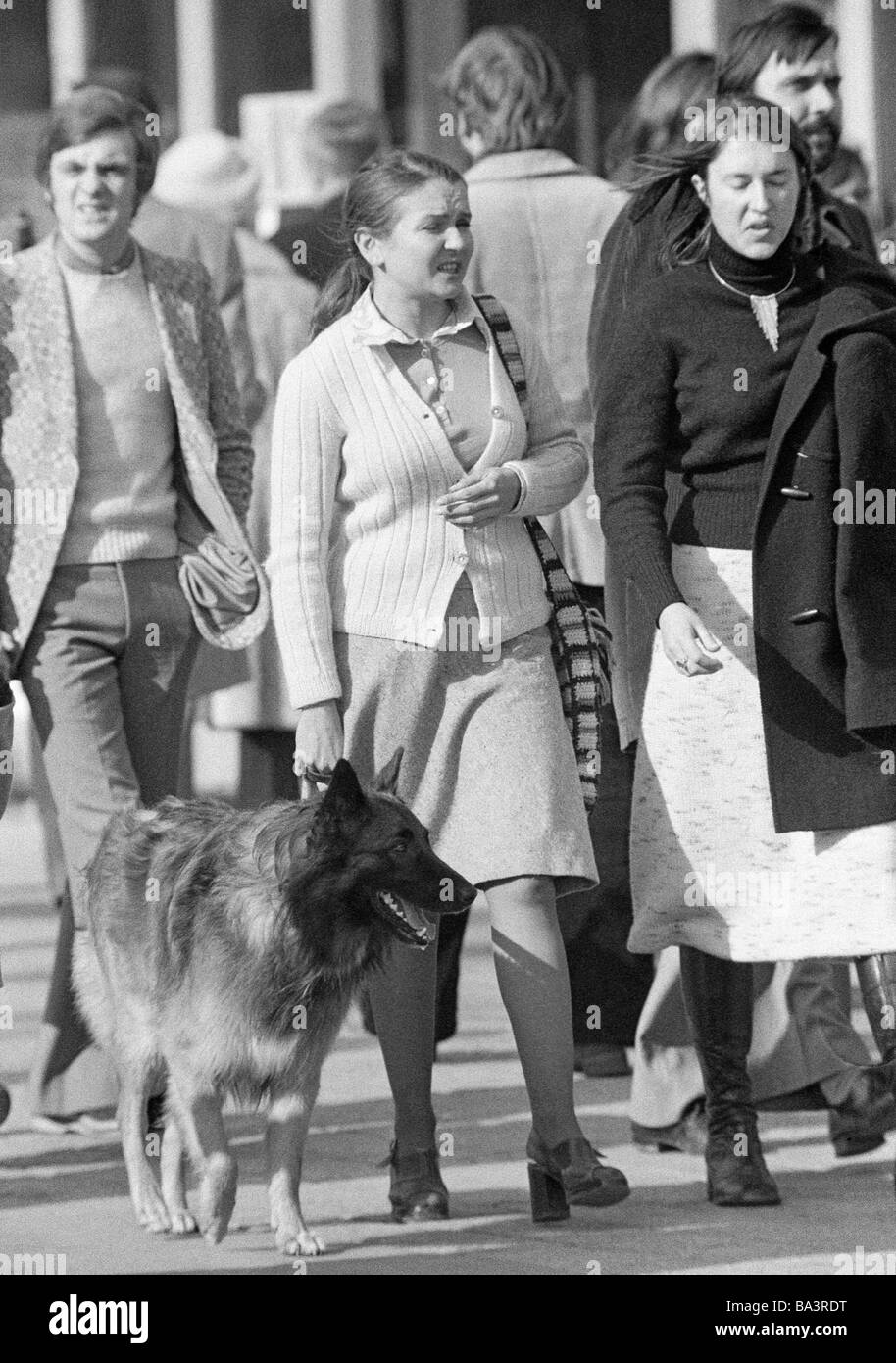 Seventies, black and white photo, people, two women with a sheepdog in the pedestrian zone, everyday life, waistcoat, skirt, aged 30 to 40 years, France, Paris Stock Photo