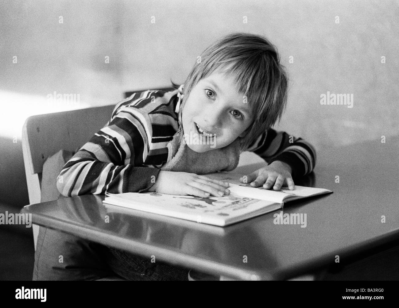 Seventies, black and white photo, people, physical handicap, school lessons, schoolboy sits at the school desk, schoolbook, aged 5 to 8 years, Special School Alsbachtal, D-Oberhausen, D-Oberhausen-Sterkrade, Ruhr area, North Rhine-Westphalia Stock Photo