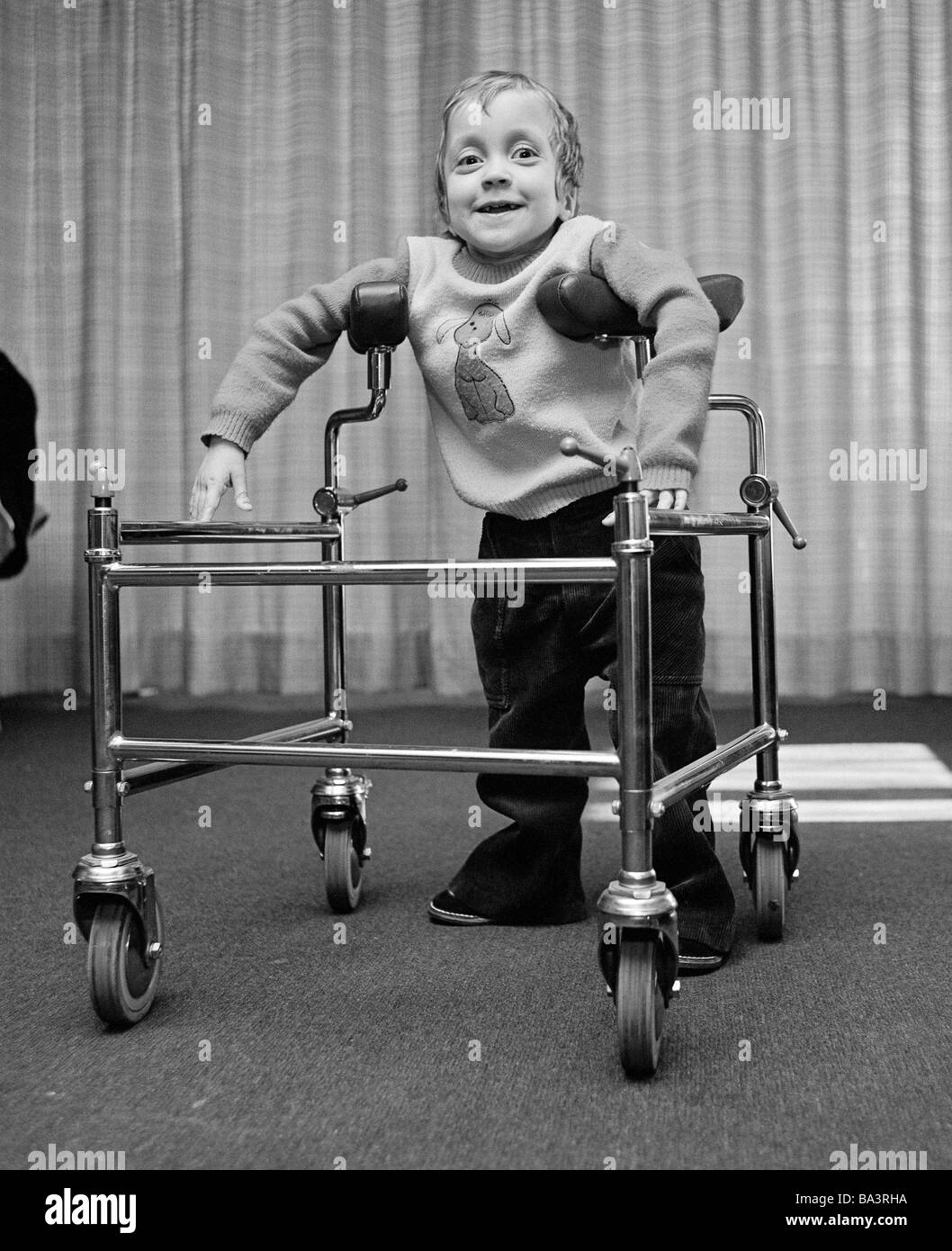 Seventies, black and white photo, people, physical handicap, school, little girl in a wheeled walker, aged 3 to 4 years, Ute, Special School Alsbachtal, D-Oberhausen, D-Oberhausen-Sterkrade, Ruhr area, North Rhine-Westphalia Stock Photo