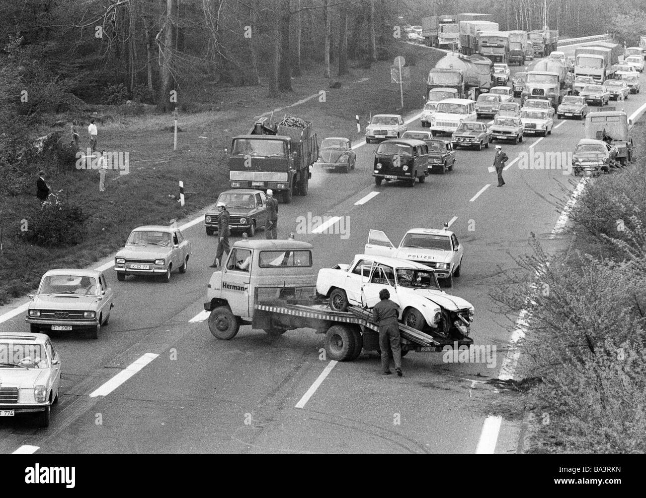 Seventies, black and white photo, traffic, car crash on the motorway A2, highway junction Oberhausen, breakdown truck, wrecked car, police car, traffic jam, gazers on the roadside, D-Oberhausen, D-Oberhausen-Sterkrade, Ruhr area, North Rhine-Westphalia Stock Photo