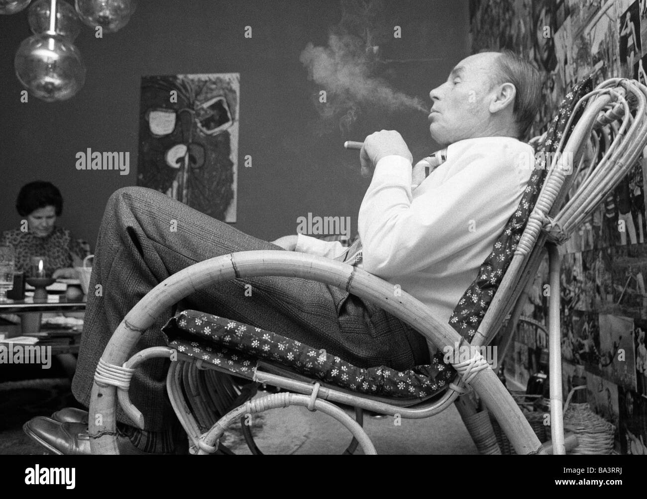 Seventies, black and white photo, people, older man sits in a rockingchair smoking a cigar, aged 60 to 70 years, Josef Stock Photo