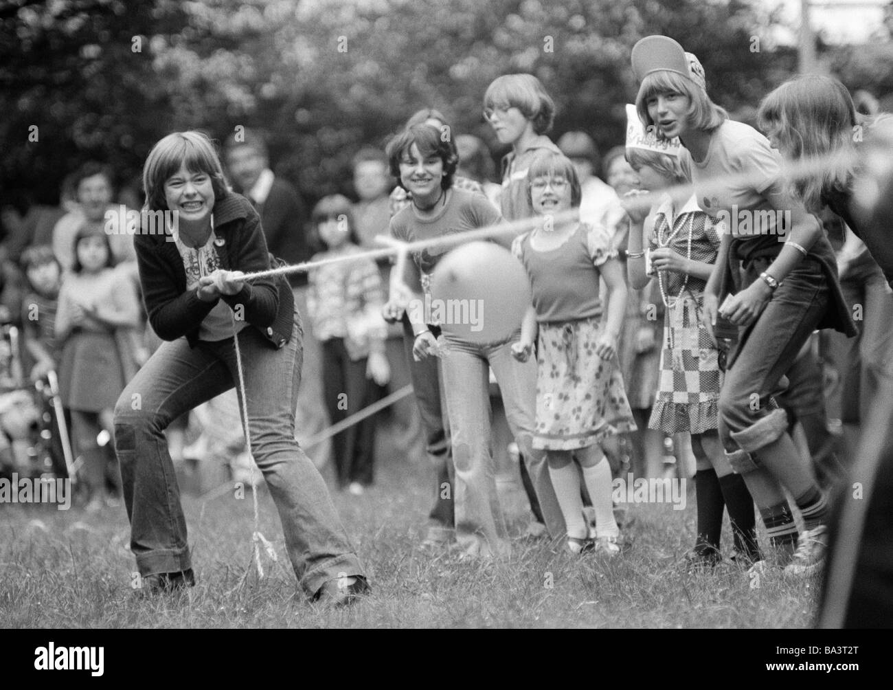 Seventies, black and white photo, people, children, girl, tug-of-war, childrens playground, aged 10 to 13 years Stock Photo