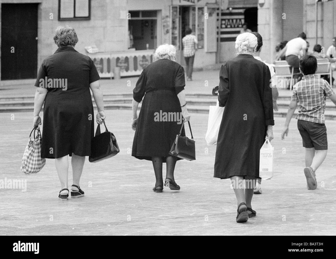 Seventies, black and white photo, people, older people, three older women completely dressed in black, shopping, shopping bags, hand bags, aged 60 to 70 years, Stock Photo