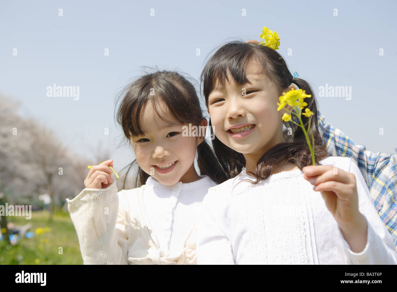 Two Japanese girls holding flowers Stock Photo