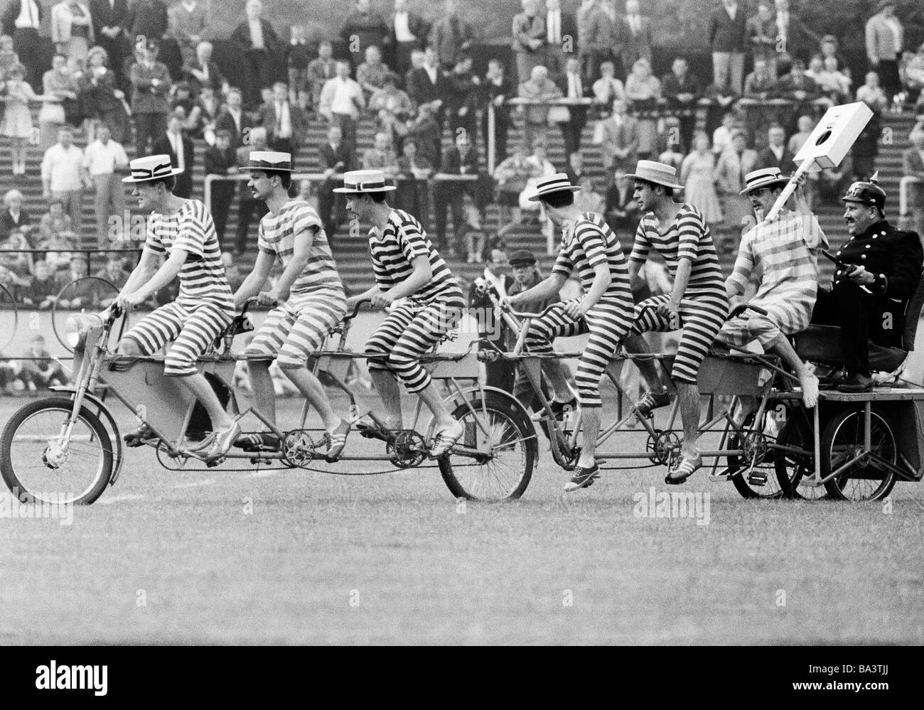 Sixties, black and white photo, event, 3rd International Police Sports and Music Festival 1966 in the Niederrhein Stadium in Oberhausen, humour, seven humorists on one bicycle, D-Oberhausen, Ruhr area, North Rhine-Westphalia Stock Photo