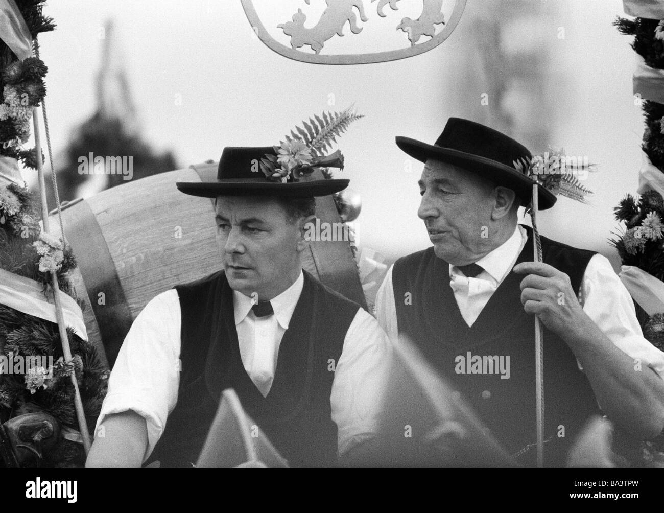 Sixties, black and white photo, folk festival, Munich Beer Festival 1966, Entry of the Oktoberfest Staff and Breweries, traditional costume parade, two men, aged 30 to 40 years, aged 60 to 70 years, D-Munich, Isar, Upper Bavaria, Bavaria Stock Photo