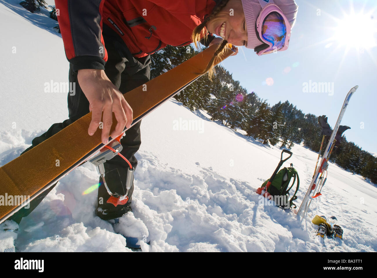 Woman prepares for backcountry skiing in Turnagain Pass of Southcentral Alaska during Winter Stock Photo
