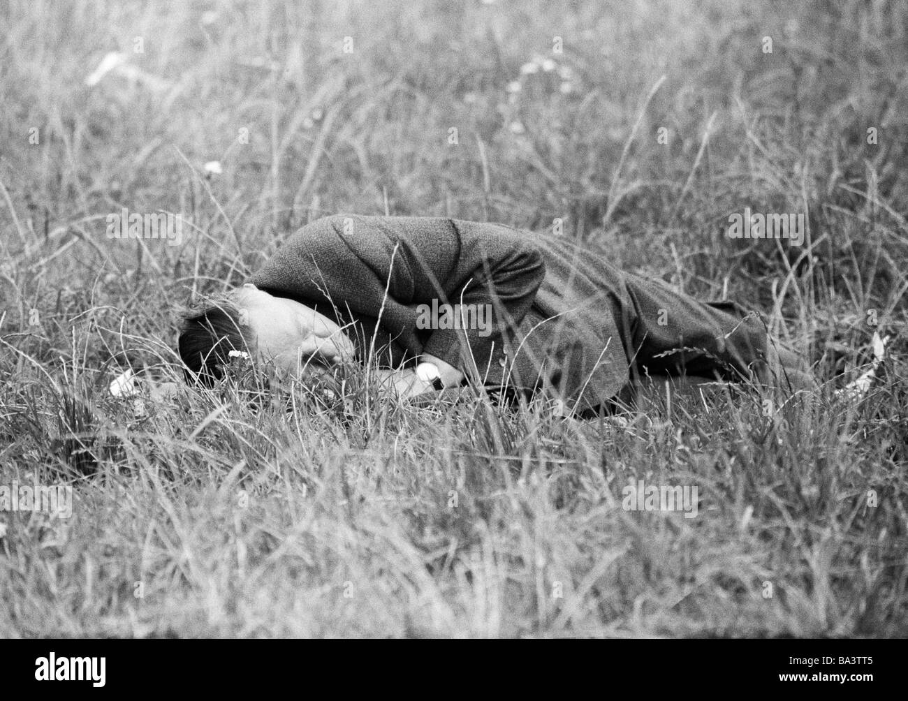 Sixties, black and white photo, people, older man lies on a meadow and sleeps of, drunken, groggily, Munich Beer Festival 1966, aged 50 to 60 years, Munich, Upper Bavaria, Bavaria Stock Photo