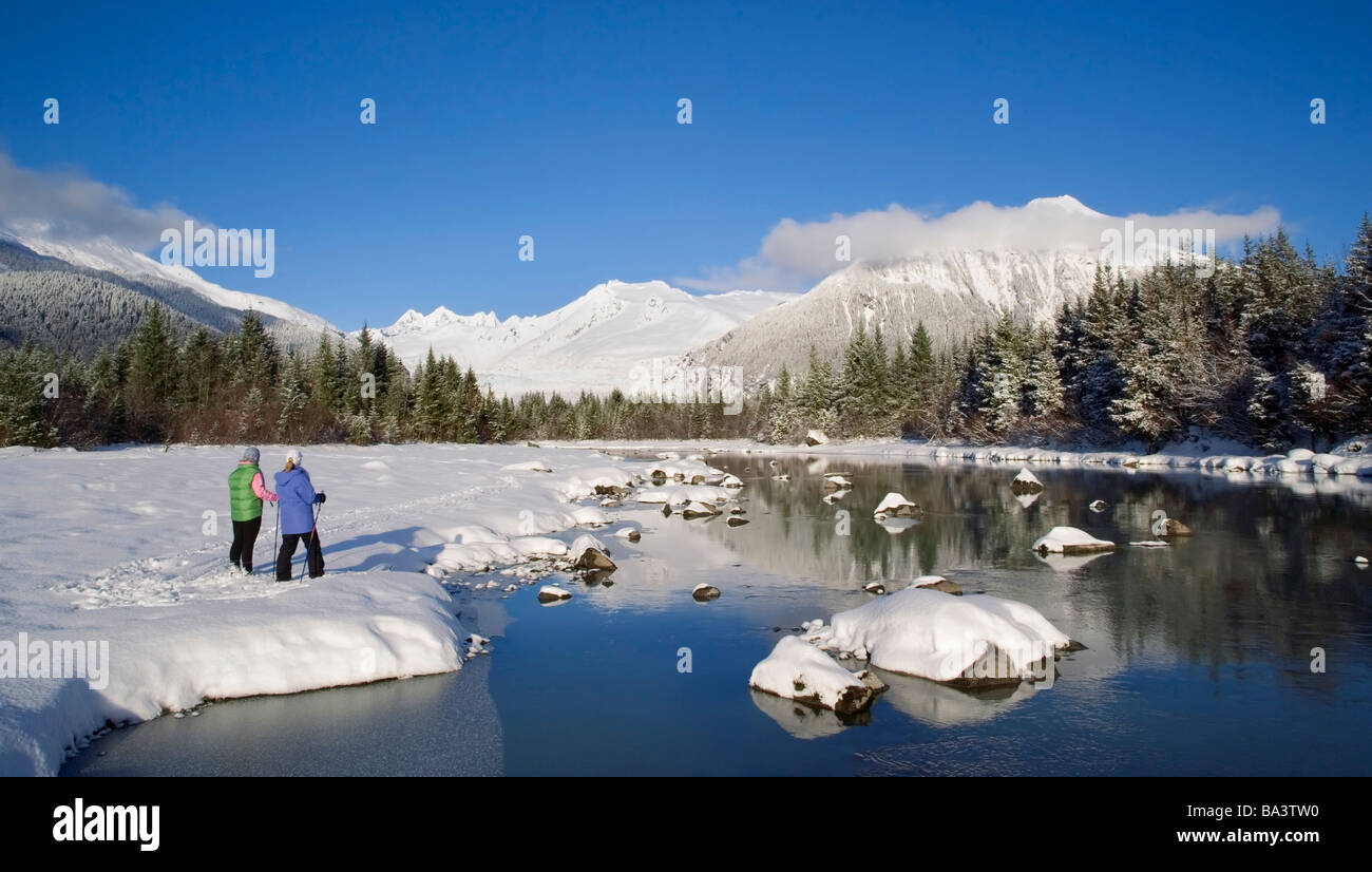 Mother & daughter cross-country skiing along  Mendenhall River Alaska Winter Tongass Nat Forest Stock Photo