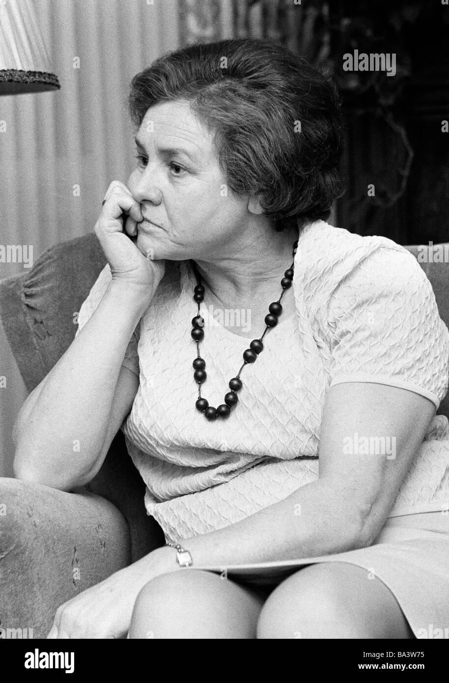 Sixties, black and white photo, people, senior, older woman sits in an  armchair, depression, portrait, blouse, skirt, necklet, aged 65 to 70  years, Kaethe Stock Photo - Alamy