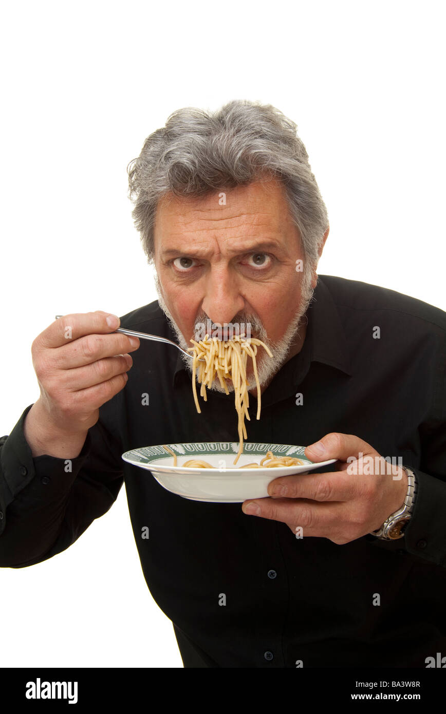 man with a mouthful of pasta Stock Photo