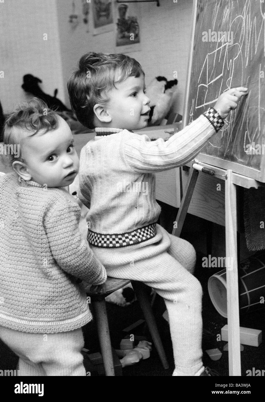 Seventies, black and white photo, people, children, little boy and little girl draw on a blackboard, aged 2 to 3 years, aged 5 to 7 years, Uta, Volker Stock Photo