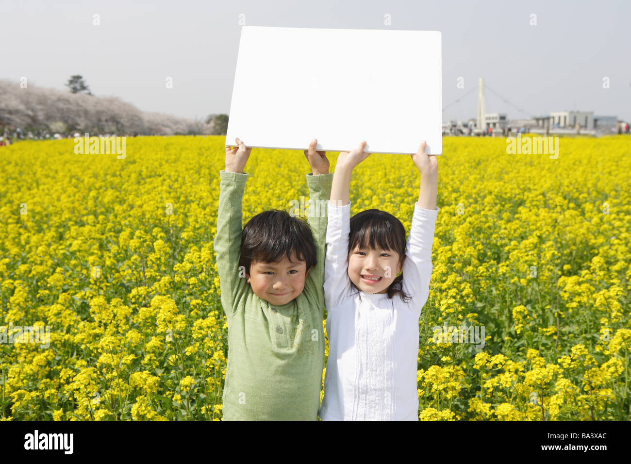 Two Japanese children holding white cardboard Stock Photo