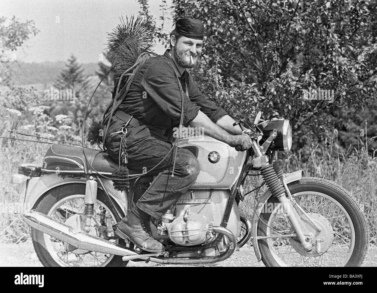 Seventies, black and white photo, business, chimney sweeper drives on a motorbike, mojo, aged 30 to 40 years, Black Forest, Baden-Wuerttemberg Stock Photo