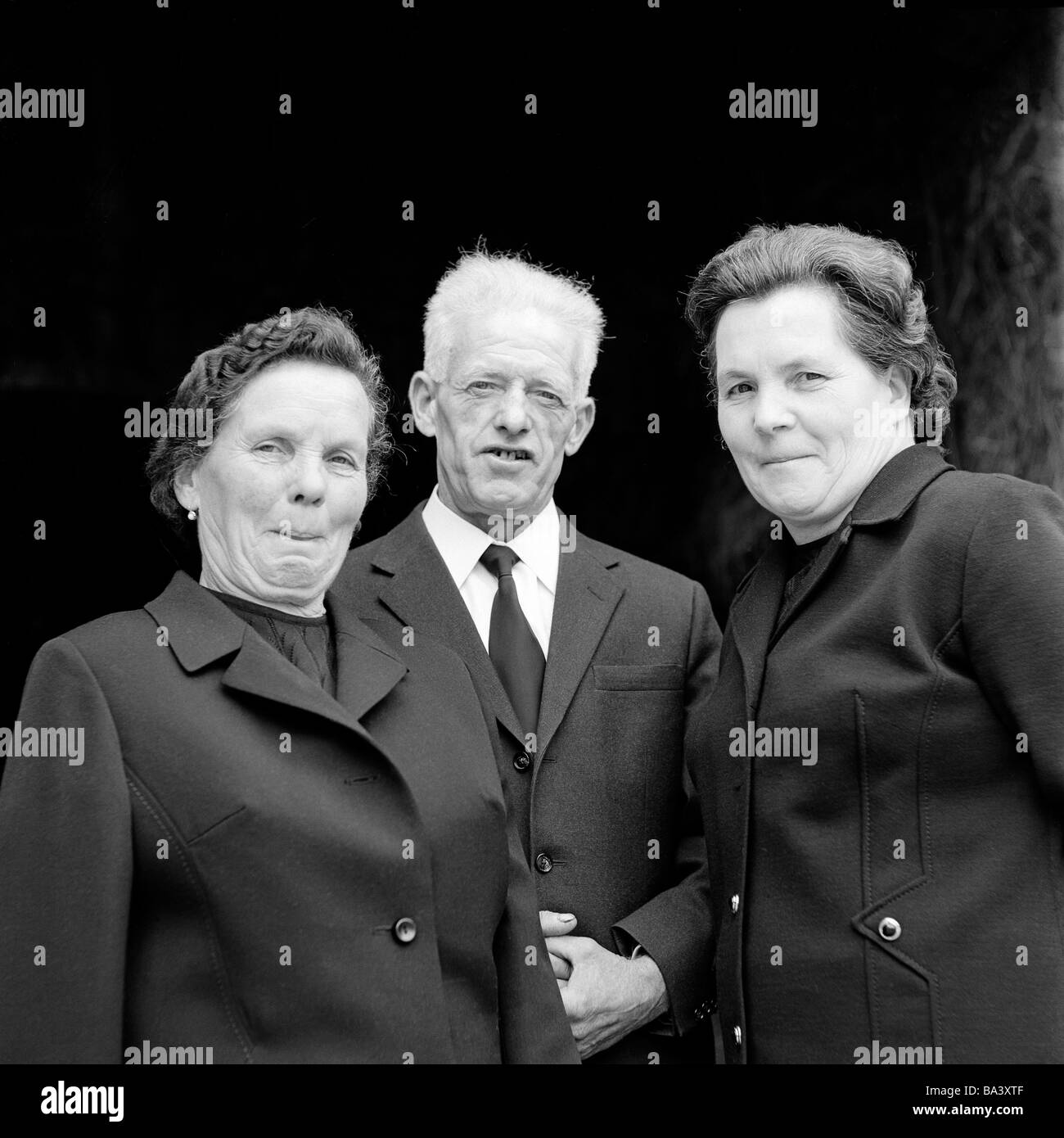 Seventies, black and white photo, people, older people, two older women and an older man in mourning clothes, black female suit, black garment, black necktie, aged 60 to 70 years, Traut, Michel, Katharina Stock Photo