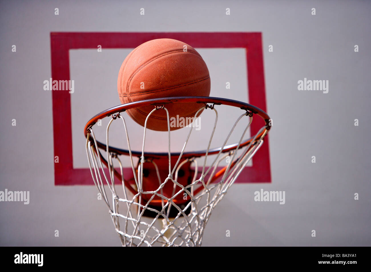 A basketball goes through the hoop Stock Photo Alamy