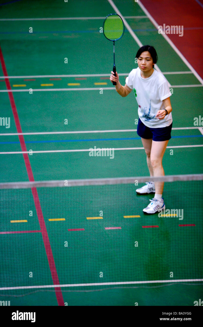 Woman poised to hit shuttlecock with badminton racket Stock Photo Alamy