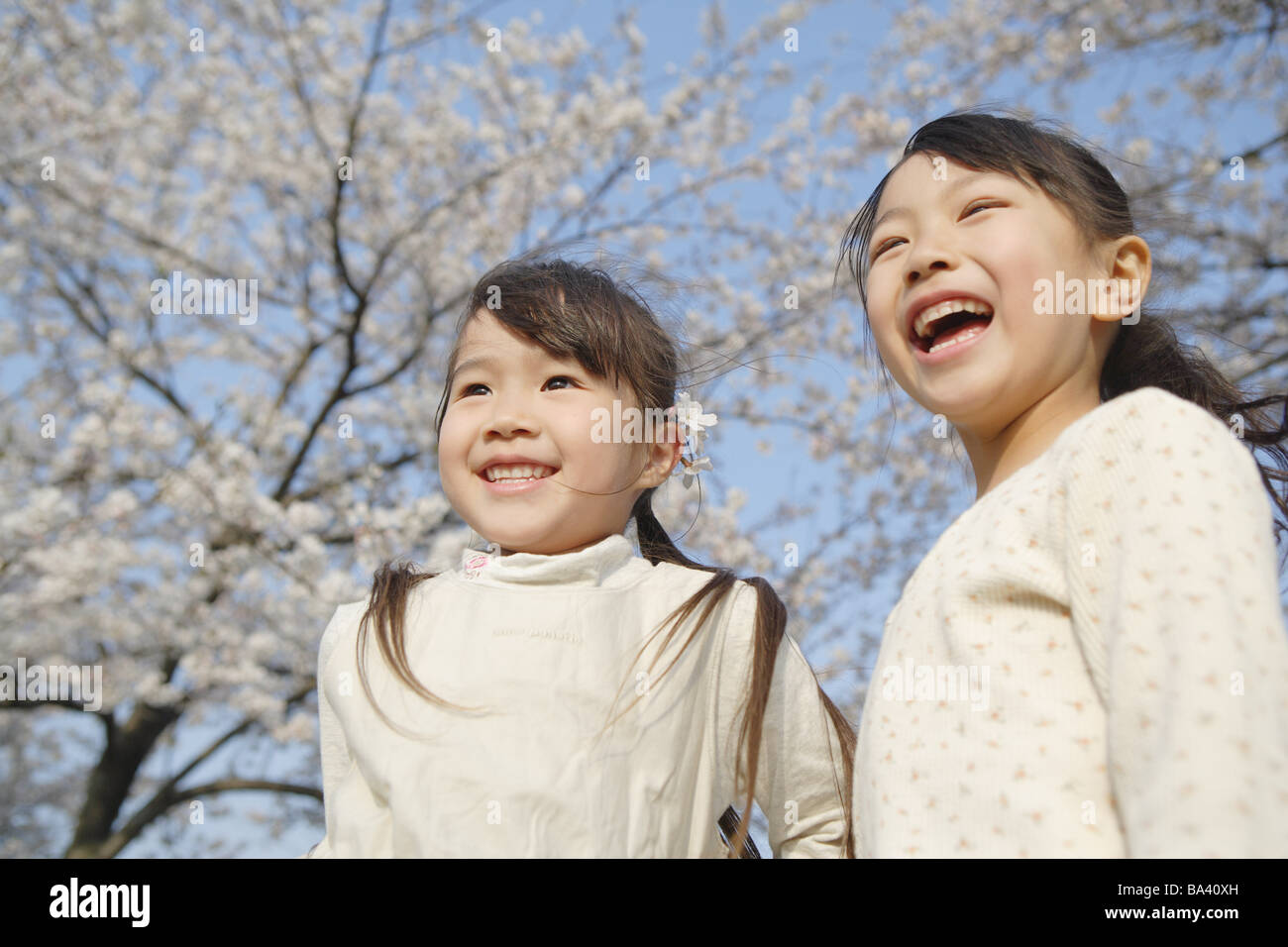 Two Japanese sisters smiling and laughing Stock Photo