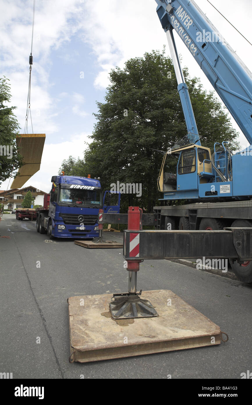 Street truck crane outriggers woodbearers begins building site