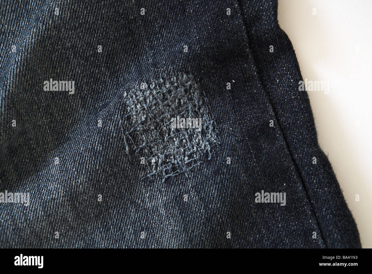Pants jeans detail mended clothing handicraft Näharbeiten jeans pant leg  hole stuffed patchwork mending repairs fact-reception Stock Photo - Alamy