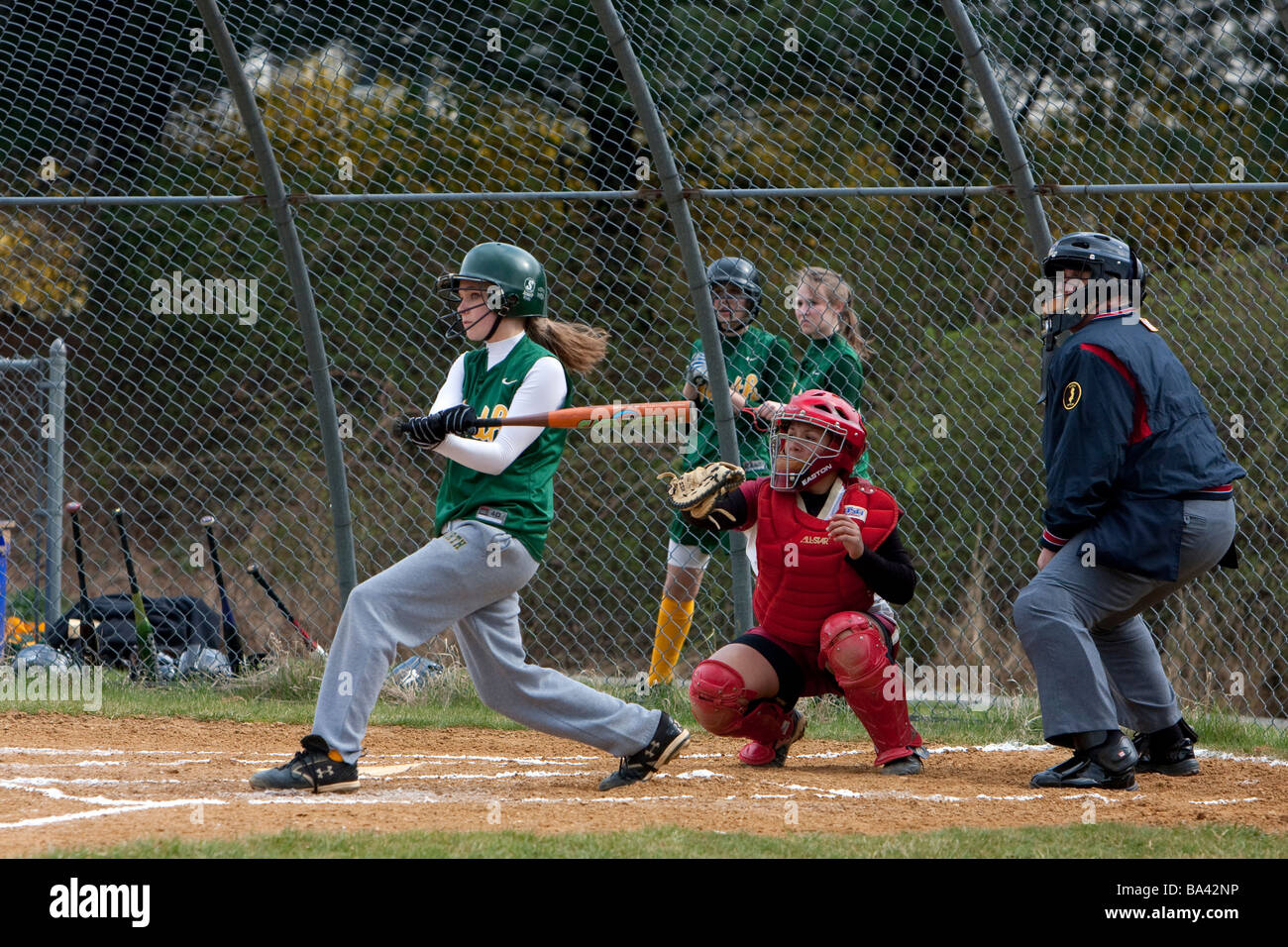 A batter, catcher and umpire at a girls high school softball game Stock