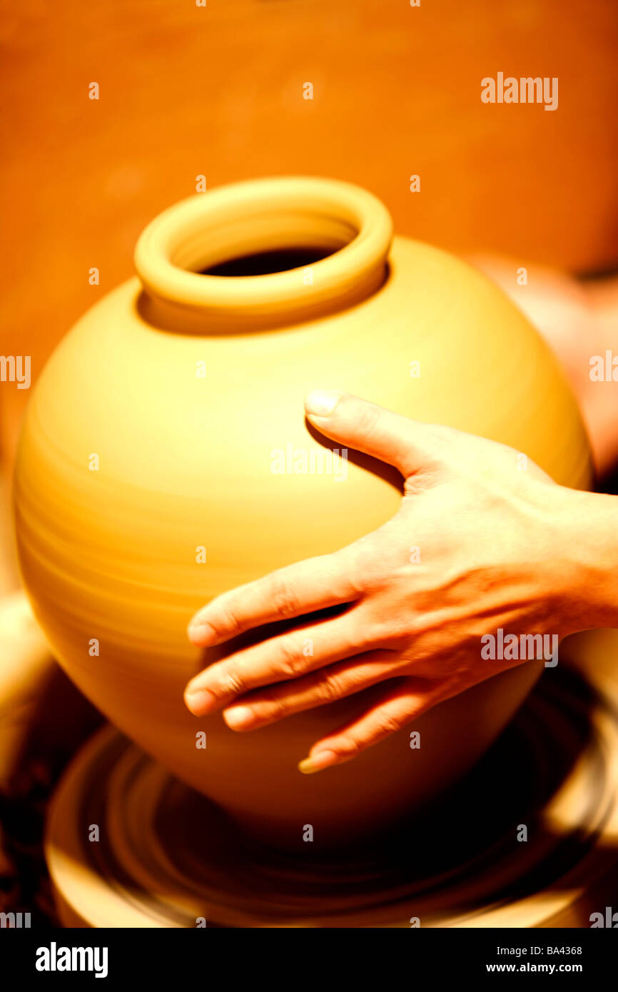 An finishing earthen pot on pottery s wheel Stock Photo Alamy