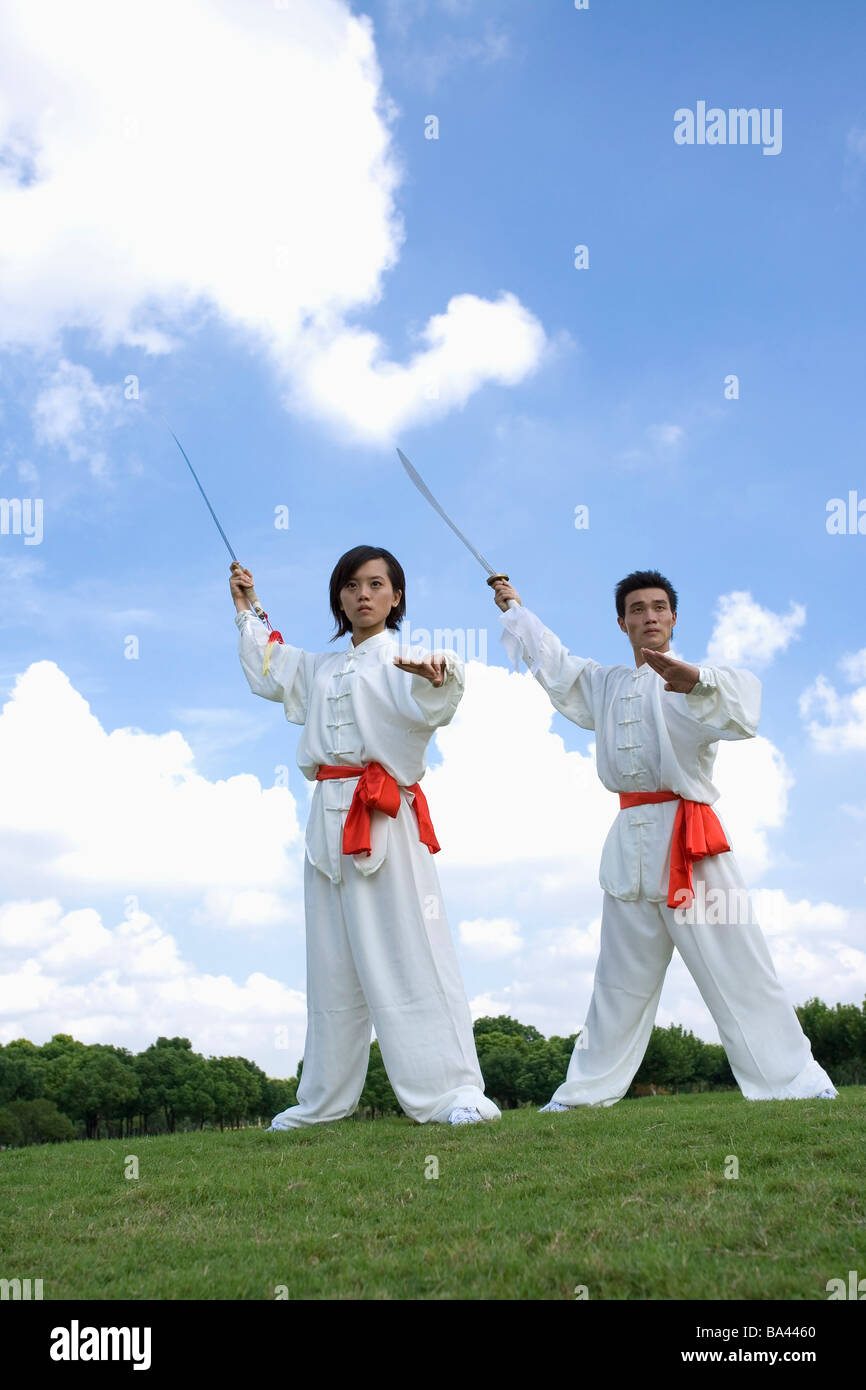 Young woman and man doing kung fu moves with sword Stock Photo Alamy