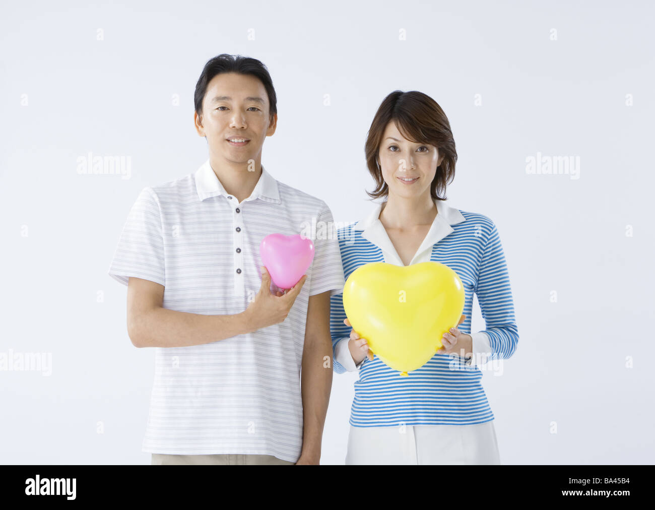 Couple holding heart shape Stock Photo - Alamy