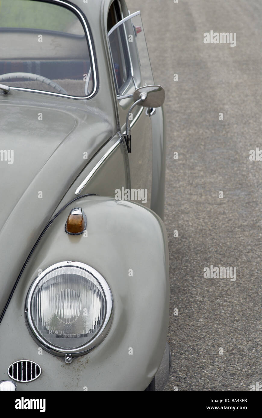 Oldtimer bugs VW-bugs year of construction 1959 headlights fenders gray parked street asphalt detail broached 05/2006 old Stock Photo