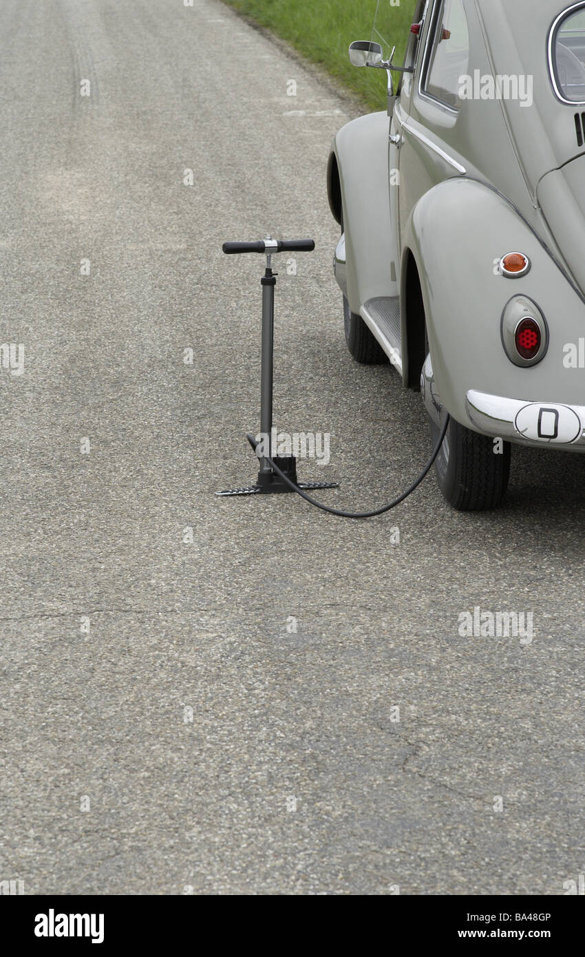 Oldtimer VW-bugs car car-breakdown detail banquets air-pump flat nobody edge-strips country road parked stopped gray year of Stock Photo