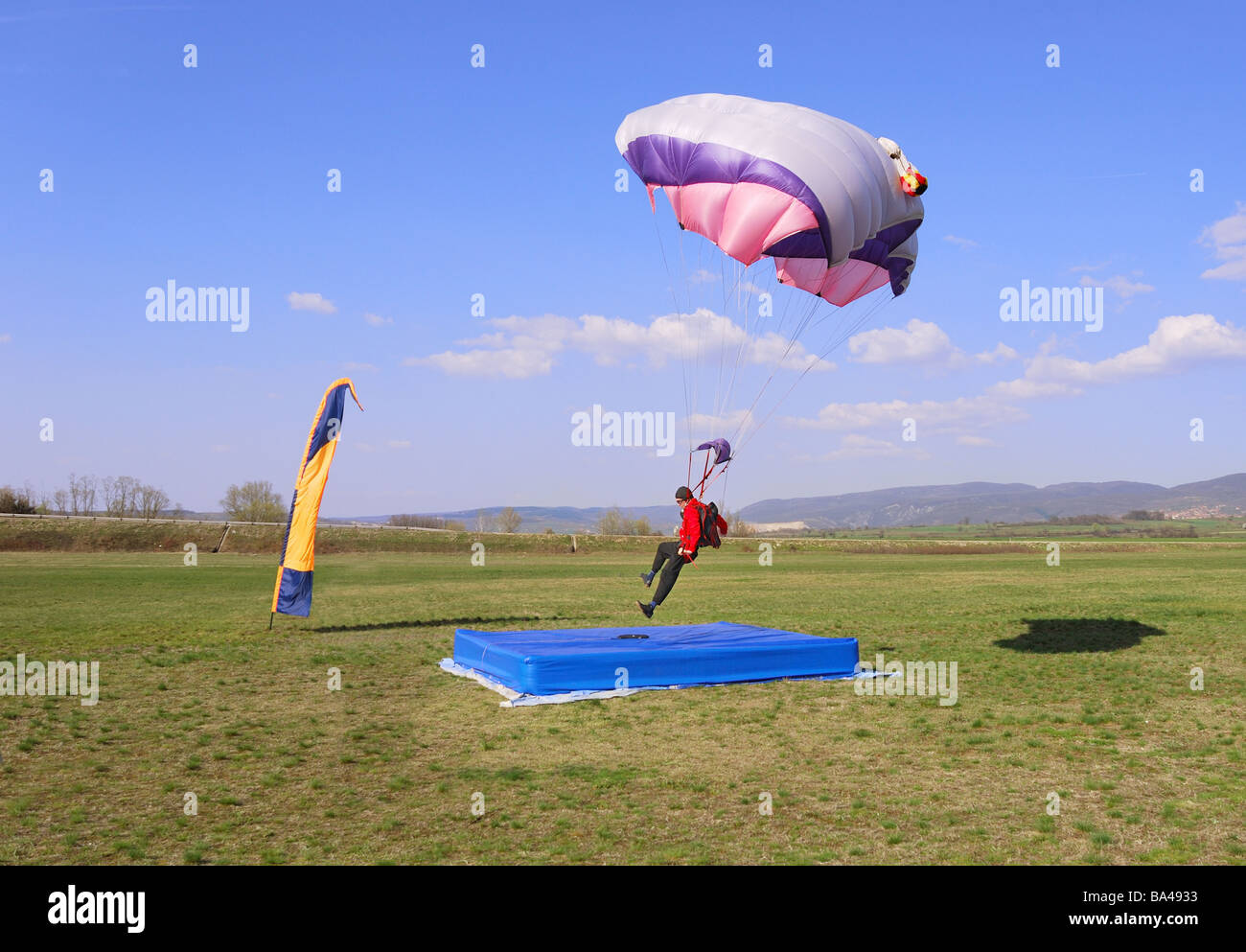 Parachutist landing right in the center of a target Stock Photo