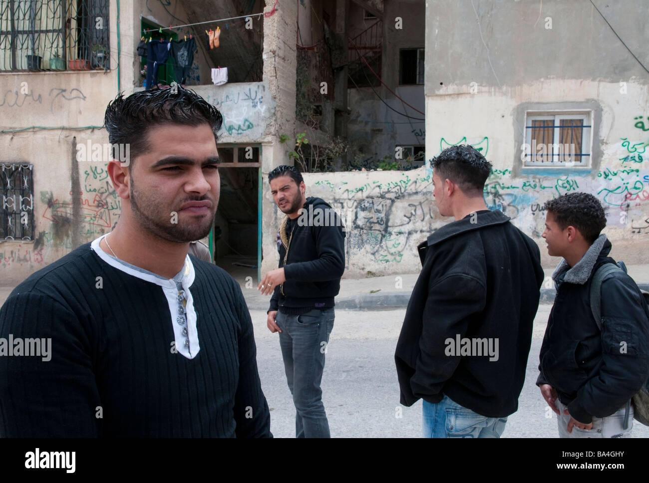 Palestinian Authority Bethlehem Aida refugee camp group of young men near Israeli wall Stock Photo