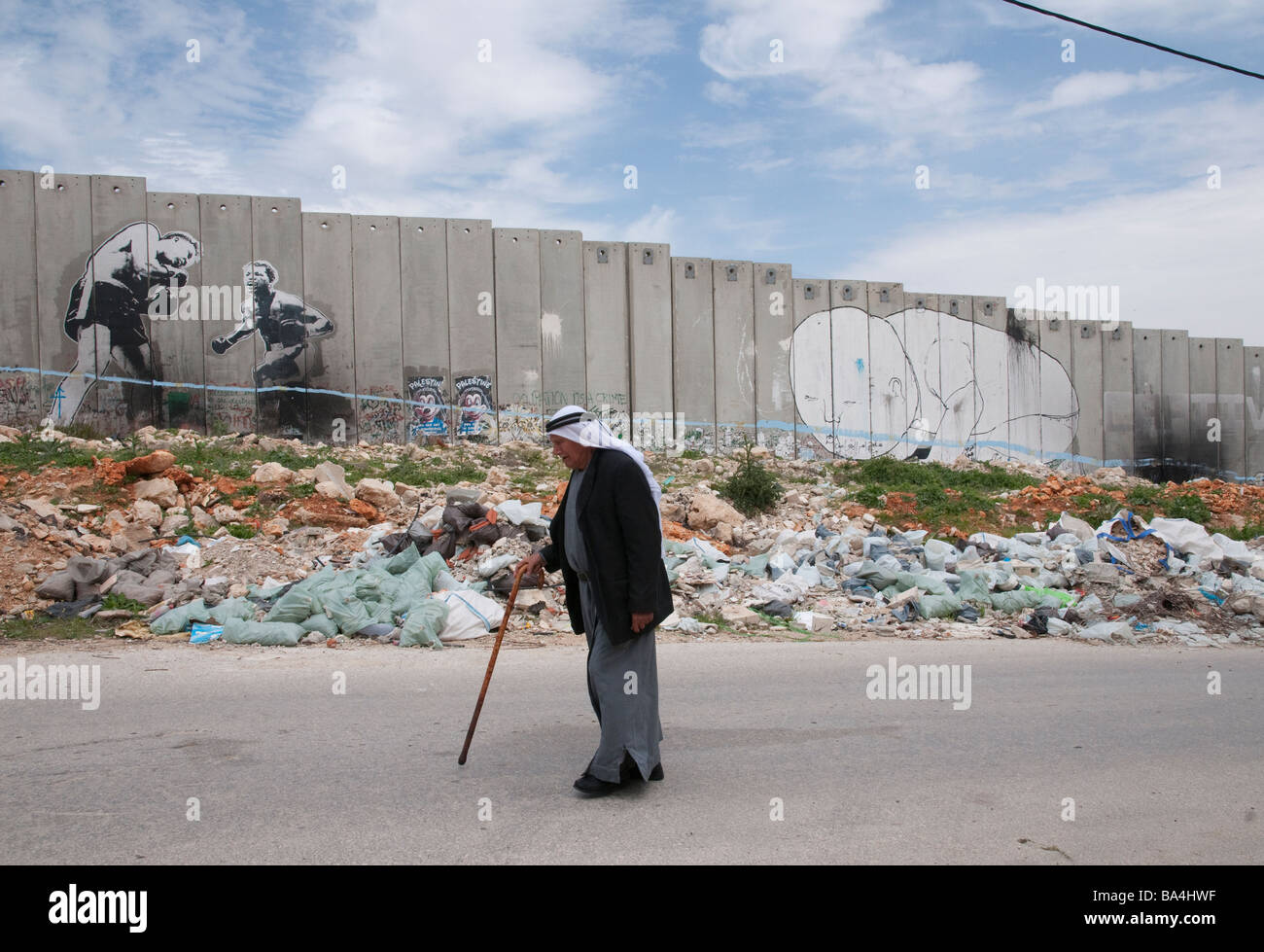 Palestinian Authority Bethlehem Aida refugee camp Palestinian elder walking passed Israeli wall Stock Photo