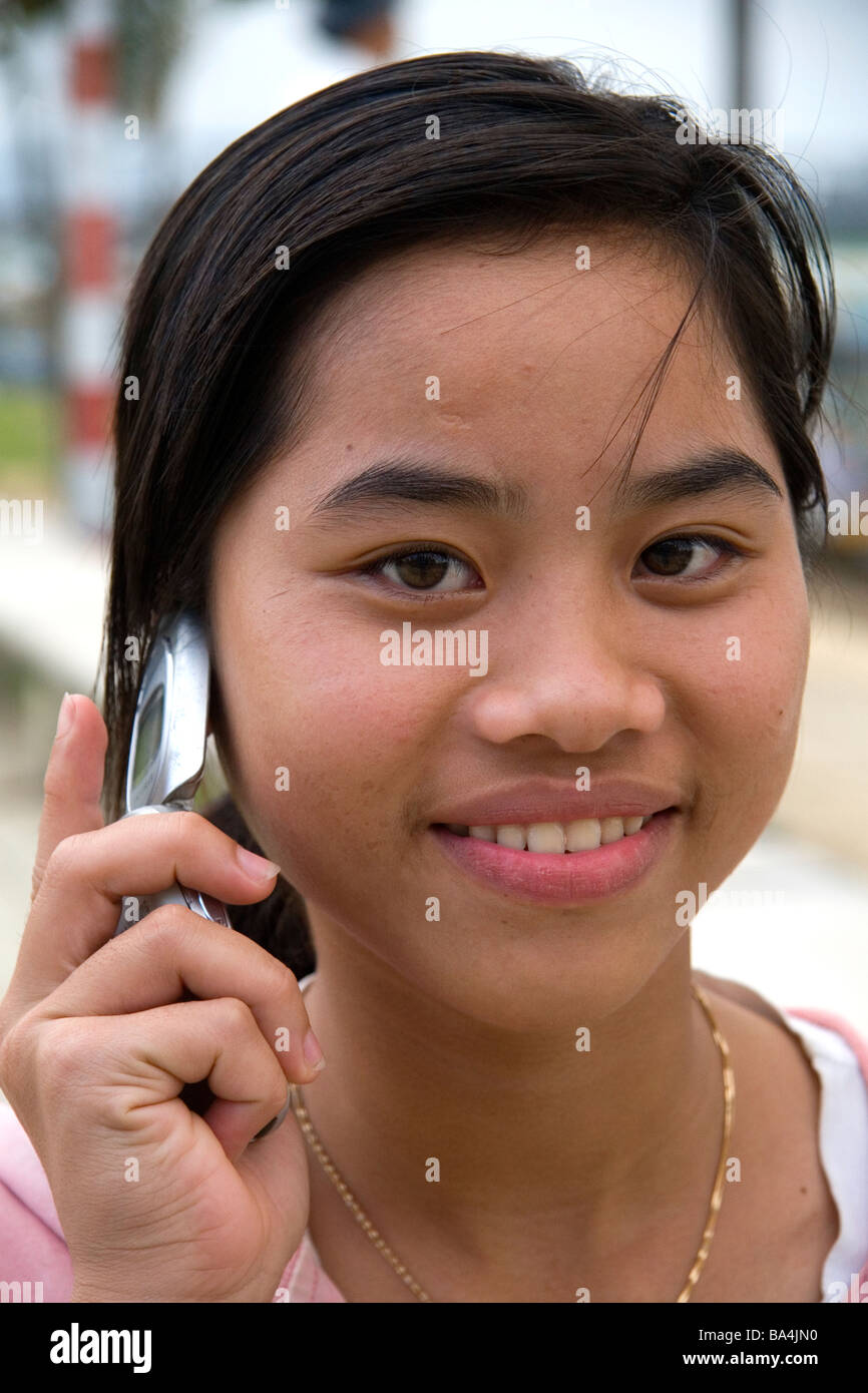 Portrait of a Vietnamese girl using a cell phone in Hue Vietnam Stock Photo