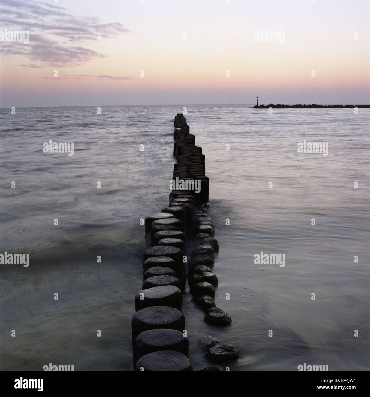 Baltic sea groynes surfwall seasigns sunrise sea water coastprotection wall breakwaters dam