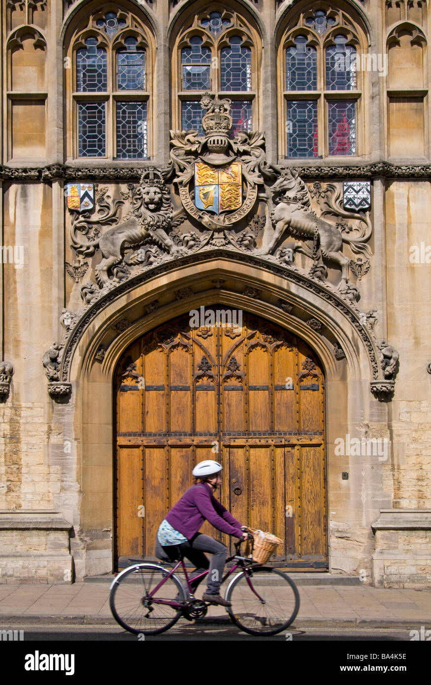 Oxford, England, UK. Brasenose College main door on the High Street. Woman passing on bicycle Stock Photo