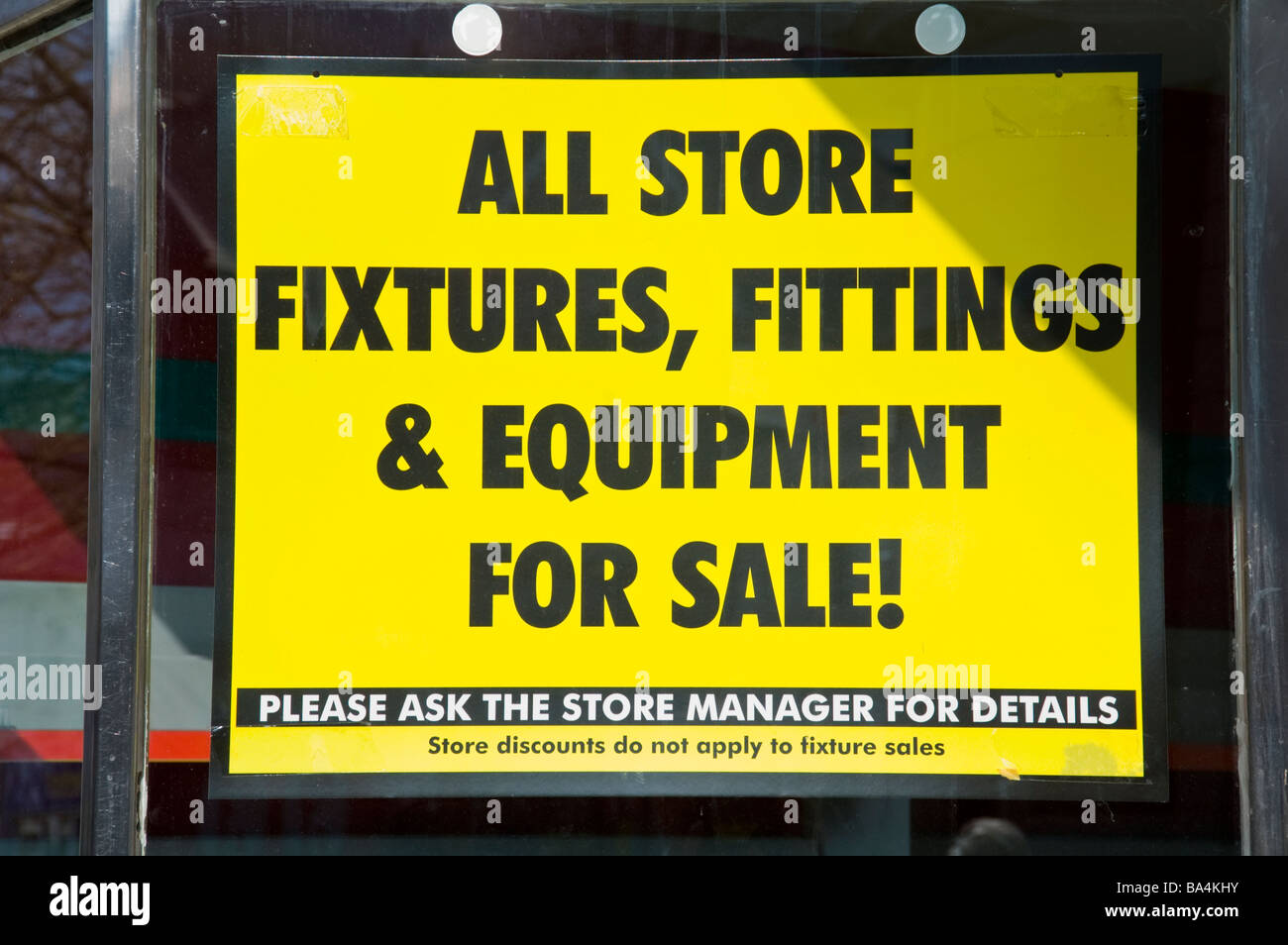 Fixtures and fittings for sale sign in empty town centre shop UK Stock Photo