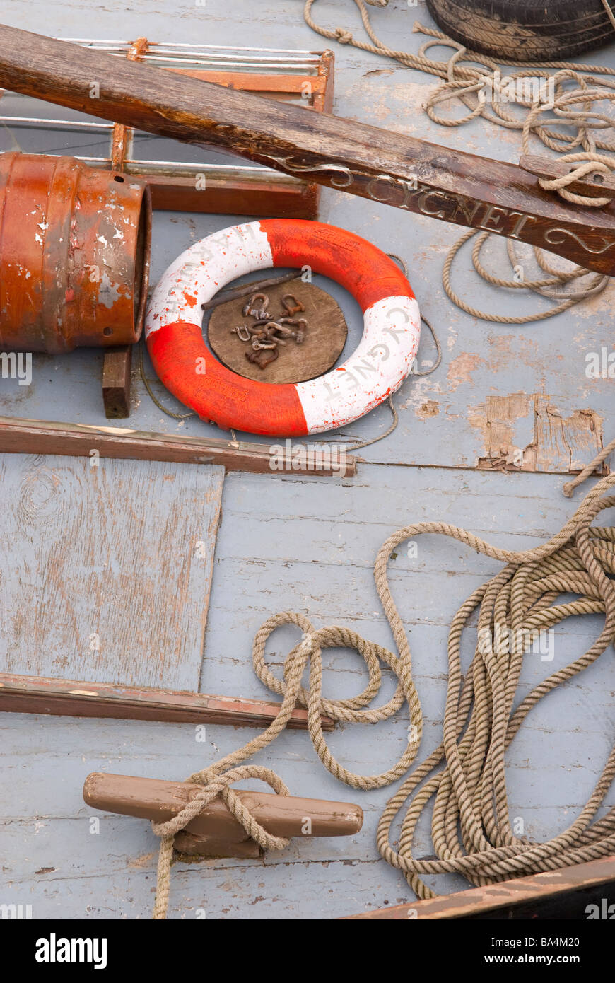 The deck of a boat with a life saving ring and rope on board Stock