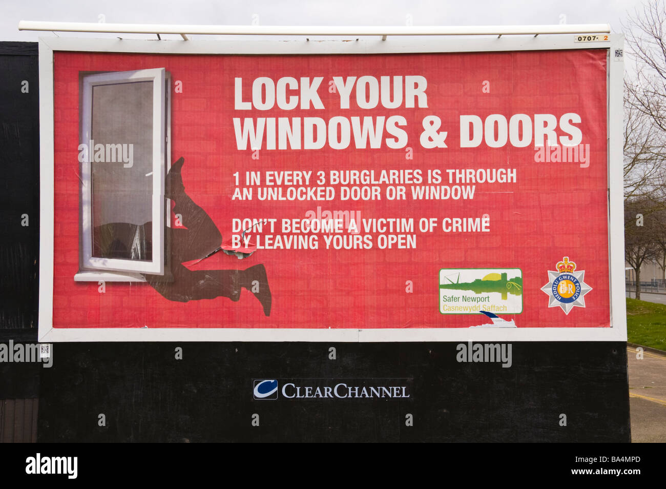 ClearChannel advertising billboard for crime prevention initative on hoardings in Newport South Wales UK Stock Photo