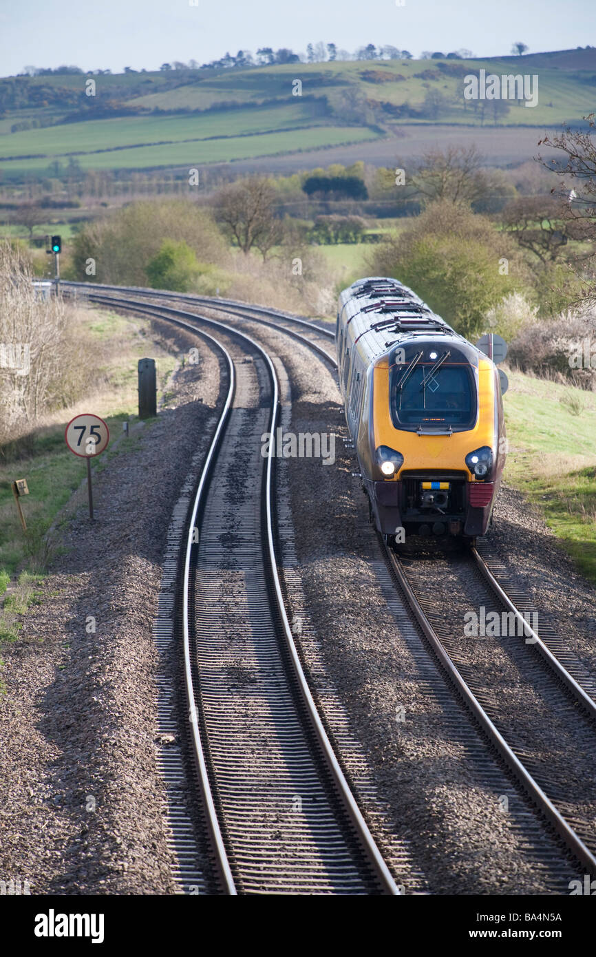 The Chiltern Main Line railway south of Leamington Spa looking South with a Cross Country Trains Class 220 Voyager approaching Stock Photo